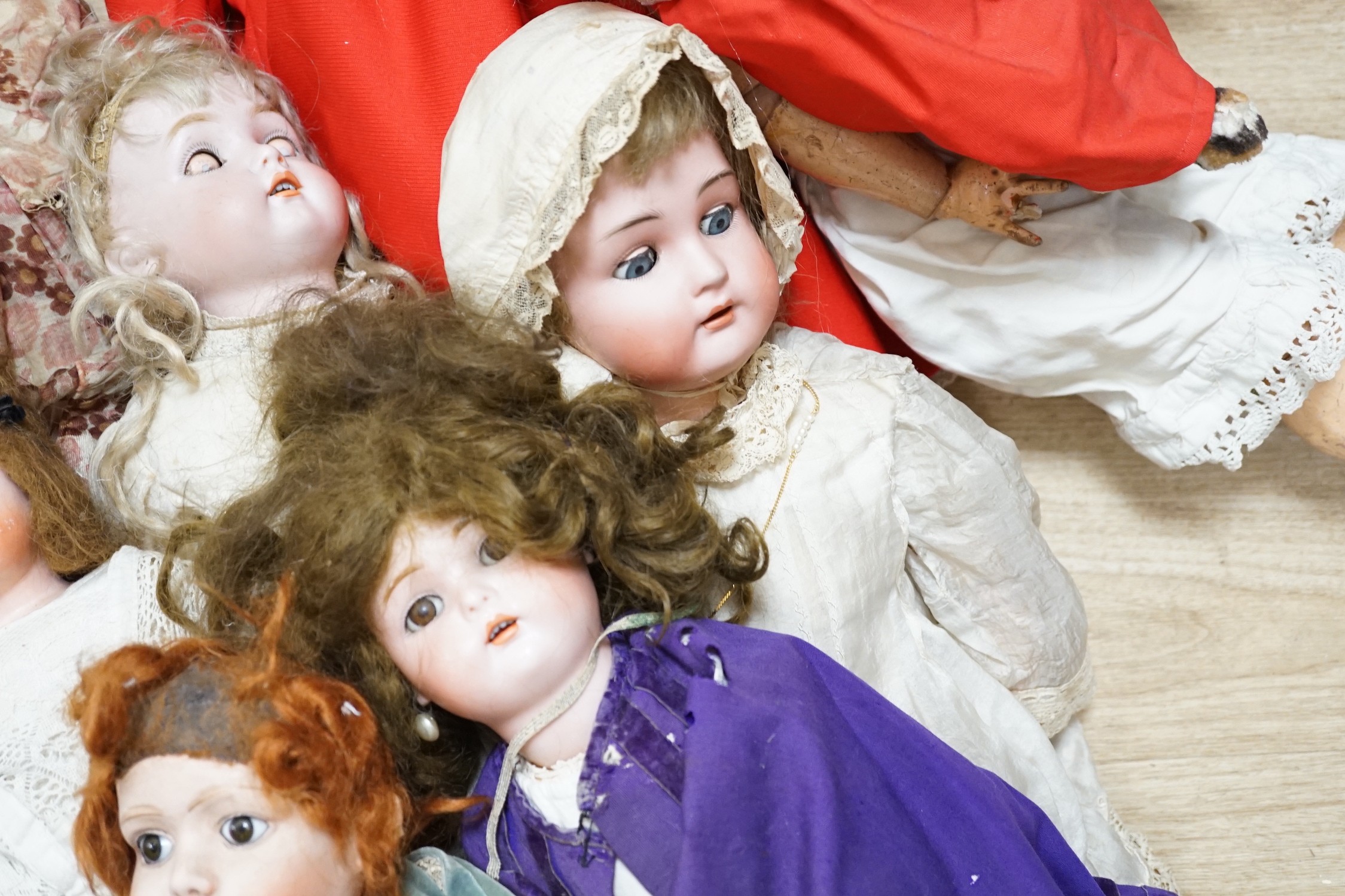 Two Kammer and Reinhardt bisque headed dolls, a wax over composition doll, various other bisque headed dolls and a few single heads and a collection of miniature dolls
